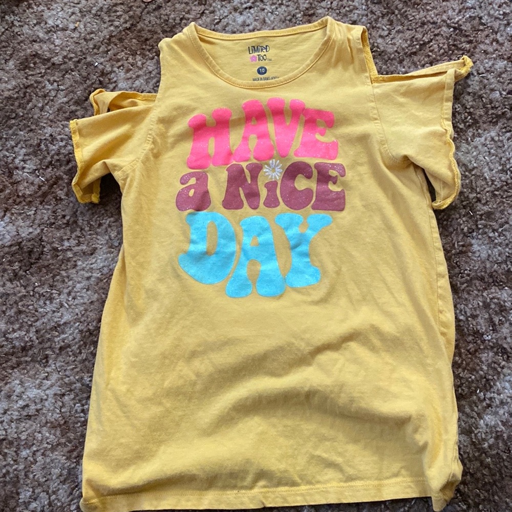 A yellow shoulder showing shirt 10 in girls